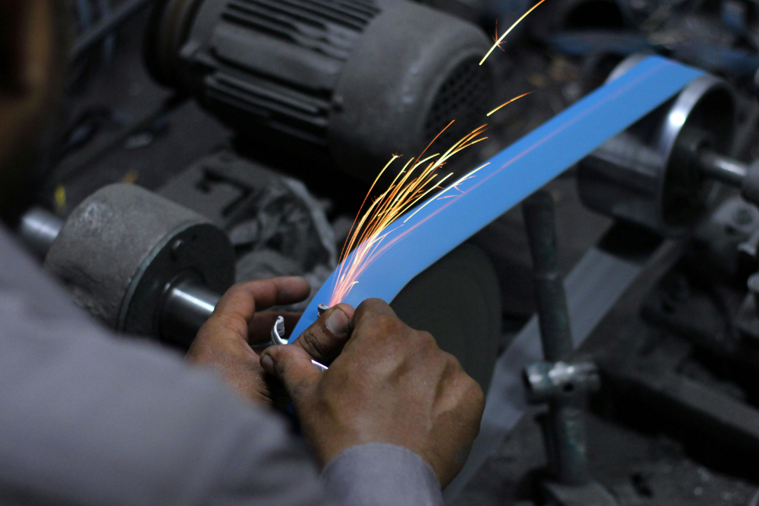 Professional 2x72 belt grinder for knife making with contact wheels and tool arms on workshop stand