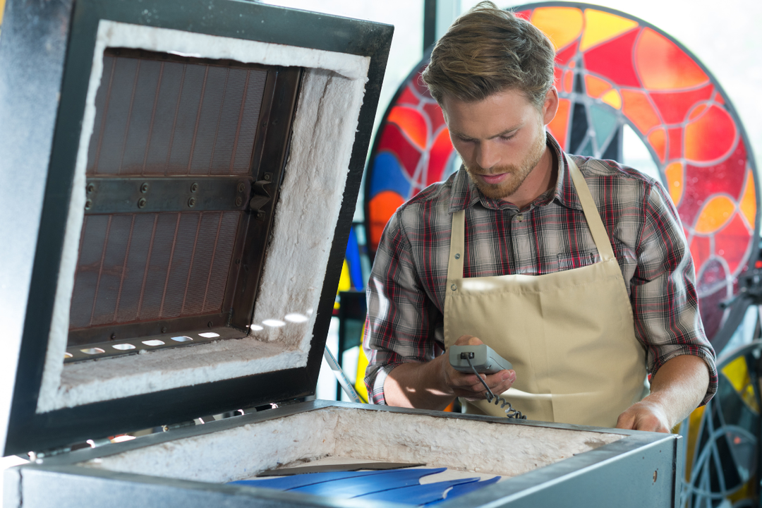 Kiln controller displaying firing schedule with temperature ramp rates and setpoints for glass and ceramic projects
