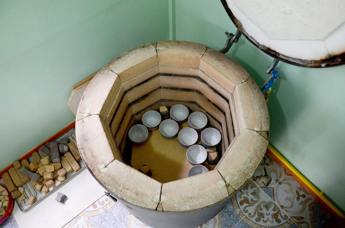 person using electric kiln at home